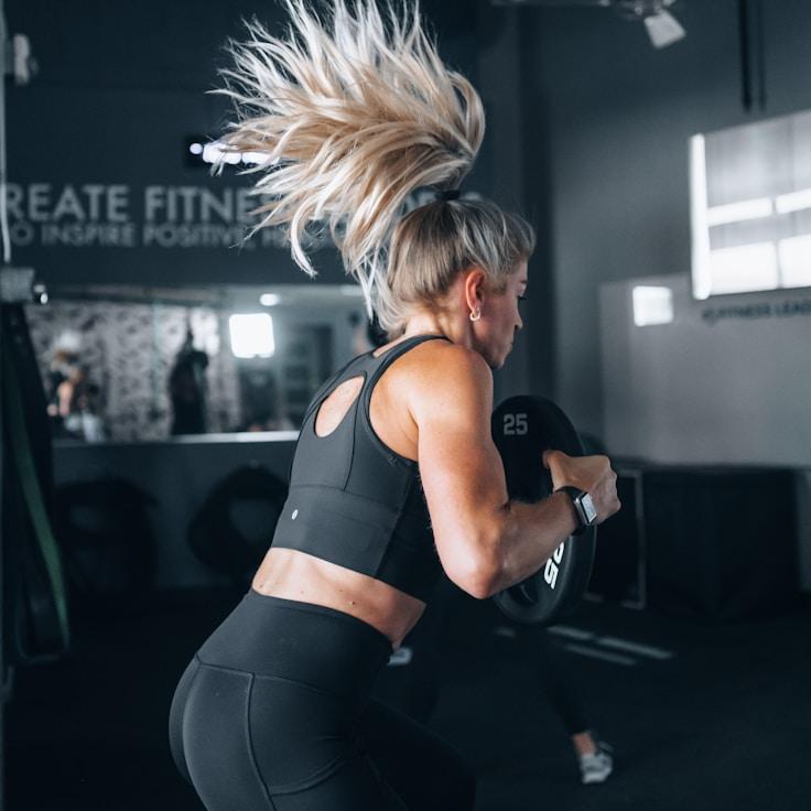 Women in a fitness class doing stretching and mobility exercises